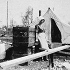 Lillie Berry in front of their tent home, 1918.