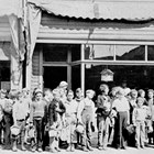 Grade school class, going out for a picnic, in front of Charles Quinton's barber shop, 1935.