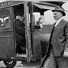 Frank Reed (standing at right) with President Warren G. Harding in the Anchorage Hotel bus, 1923.