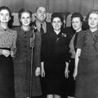 Thomas "Tom" Bevers, who was instrumental in establishing the Fur Rendezvous, here stands with the candidates for Fur Rendezvous Queen on February 4, 1941: Patsy Chisolm, Vivian Fisher Chevillon, Wanda Gelles Griffin, Roberta Lee, and Virginia “Ginger” Schodde.  Chisolm was selected as queen.  Bevers was manager of the Fur Rendezvous in 1941.
