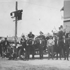 Anchorage Fire Department, 1924.  Thomas "Tom" Bevers is the man standing third to the right of the vehicle’s front tire.  At the time this photograph was taken, Bevers was a paid firefighter in a mostly volunteer fire department.  