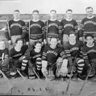 Anchorage hockey team, now equipped with better uniforms.  Thomas "Tom" Culhane is standing on the right end of the back row.  ca. 1937.