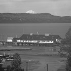 A view of the Emard Cannery along the Anchorage dock, ca. 1940.  Mount McKinley (now Denali) looms on the horizon. 