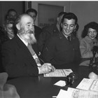 Photograph of Jacob “Russian Jack” Marunenko and friends with his naturalization paperwork at the U.S. District Court at Anchorage.