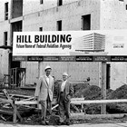 Donald "Don" and Harry Hill in front of  the Hill Building, 6th Avenue and G Street, Anchorage, during construction, ca. 1961.