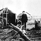 Building the Johnson family log cabin at 5th Avenue and Denali Street, Anchorage, ca. 1916. 