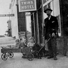 John Casey McDannel with the twins (Mary and Helen), right, and unidentified child, left, in wagon, 1918.