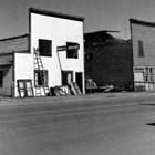 Photograph caption reads: "Family home next to White House being torn down making room for new court house."