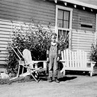 James Nelson in front of his family's first home on Government Hill in Anchorage, ca. 1940.