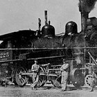"Joe Bush" Elms; Thomas "Tom" Peterkin, engineer; "Red" Brennan; and Adolph Young with Alaska Railroad Locomotive No. 225.