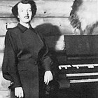 Evangeline Rasmuson Atwood, standing at the organ in her home in the Turnagain neighborhood of Anchorage, February 6, 1954.