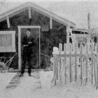 August "Gus" or "Gust" Seaburg in front of his first Anchorage home, 4th Avenue and Eagle Street, 1925.
