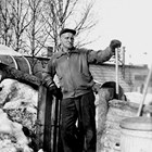 Charles Wahl doing maintenance work on his property.  Wahl's home was located at 220 East Third Avenue, Anchorage.