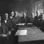 The first city council after incorporation, 1920, together with the city's clerk, attorney, and engineer. Michael Conroy is fourth from the left. Conroy was city clerk, the highest paid city employee with wide-ranging responsibilities. Mayor Leopold David is in the center of the photograph.
