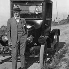 Sydney Laurence standing in front of a Model T Ford in 1928. There are a number of photographs of him with automobiles, although several stories indicate he was not a good or enthusiastic driver.  Early Anchorage settler Nellie Brown took this photograph and later recollected that he let her drive him around in the automobile, and later the Model T  became Nellie’s.  