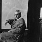 Laurence wearing an artist’s smock, holding a paintbrush, and posed near a painting easel.  As Laurence became older, he wintered in Los Angeles, California and usually summered in Anchorage.  He kept a painting studio in the Hotel Anchorage.