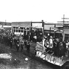 Behind the parade float, next to the Montana Pool Room, is the Brown & Hawkins store in downtown Anchorage. The store, one of the largest in Anchorage, went out of business at the end of 1925, a casualty of the financial decline that struck Anchorage during World War I and accelerated after the completion of the Alaska Railroad.    
