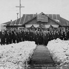 Photograph of members of the Elks (Benevolent and Protective Order of Elks, or B.P.O.E.),  a prominent men’s social organization in Anchorage, around 1918.  The large Elks Hall in downtown Anchorage was an important meeting place as well as a center for social events.  Charles Bush was an early member and officer of the group.  