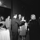 Dan and Betty Cuddy in 1977, in the center of the image, facing the photographer. The man standing with his arm outstretched is U.S. Senator Ted Stevens; Mrs. Stevens has her back to the camera.