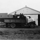 Walt’s Transfer carrying an overly long boat, with a group of men aboard to hold the boat in place. Later in life Culhane remembered that they would carry anything they could to generate business.
