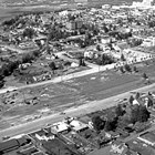 The Delaney Park Strip after the Good Friday Earthquake, March 1964.  A series of wavy brown lines show where fissures had opened in the ground because of the earthquake.  Named for James Delaney, Delaney Park (the Park Strip) remains a recreational center for Anchorage.