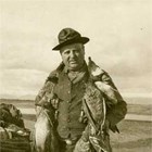 Christian "Chris" Eckmann with the waterfowl that he shot in Cook Inlet.  Hunting waterfowl in the fall was a major activity in early Anchorage, with groups of friends chartering boats from the ‘mosquito’ fleet to take them to the west side of Cook Inlet to hunt. A brief note in the Anchorage Daily Times on August 30, 1926, reads: “Duck hunting is the main topic of discussion about town and will probably hold the center of interest for some time.”