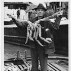 Henry Emard with a large king crab, ca. 1940-1950.