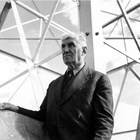 Austin E. "Cap" Lathrop, the builder and owner of the Midnight Sun Broadcasting Company's broadcasting station KFAR in Fairbanks. He is shown at the company's transmission tower, holding blueprints. This photograph was probably taken around the time KFAR's new 5,000-watt transmitter first went into action on September 26, 1942. KFAR became the most powerful radio station in the territory and its signal covered nearly all of Alaska.