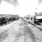 A view of Anchorage’s Fourth Avenue, looking the other way during the Fourth of July Parade, with Arthur A. Shonbeck’s store on the left.
