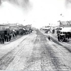 A view of Anchorage’s Fourth Avenue, looking the other way during the Fourth of July Parade, with Arthur A. Shonbeck’s store on the left.   