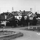 A view of Christensen Road, which curves uphill from the railroad yards at Ship Creek to what is now downtown Anchorage, where all the streets are straight and meet at right angles. Many of the Alaska Railroad executives, such as Colonel Frederick Mears, lived in government built houses along the road, in an area known as “Snob Hollow.”