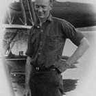 Russel Hyde Merrill in work clothes before the fuselage of a sea plane, ca. 1925.