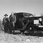 Otto Ohlson (middle) in front of his specially equipped automobile that could run on railroad tracks.  During Ohlson's tenure as manager, he had two cars that were so equipped.  The man on the left of the photograph is B.S. Snell; the man on the right is Colonel L.P. Hunt.